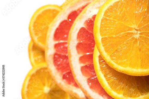 Orange and grapefruit rings are shot close-up with selective focus as background