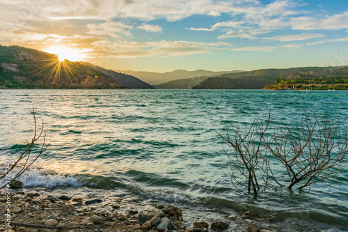 Pantano Beznar with a sky of clouds at sunset.