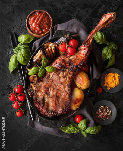 Baked lamb leg with vegetables and sauce. Roasted meat. The view from the top