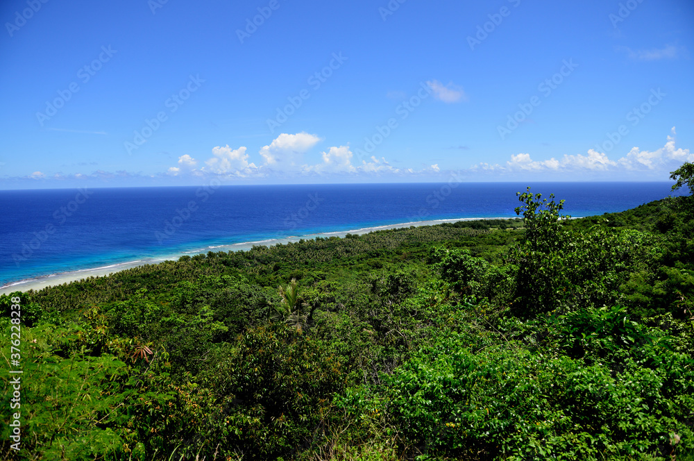 Lush green tropical vegetation and deep blue seas, high angle view above Ritidian Point, Guam, Micronesia