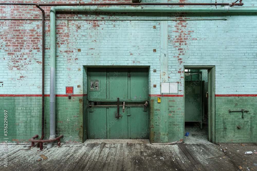 Industrial elevator and open doorway in an abandoned factory in the deep south