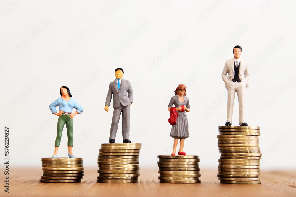 © tomertu - Conceptual image of gender inequality. A women and a men with income difference