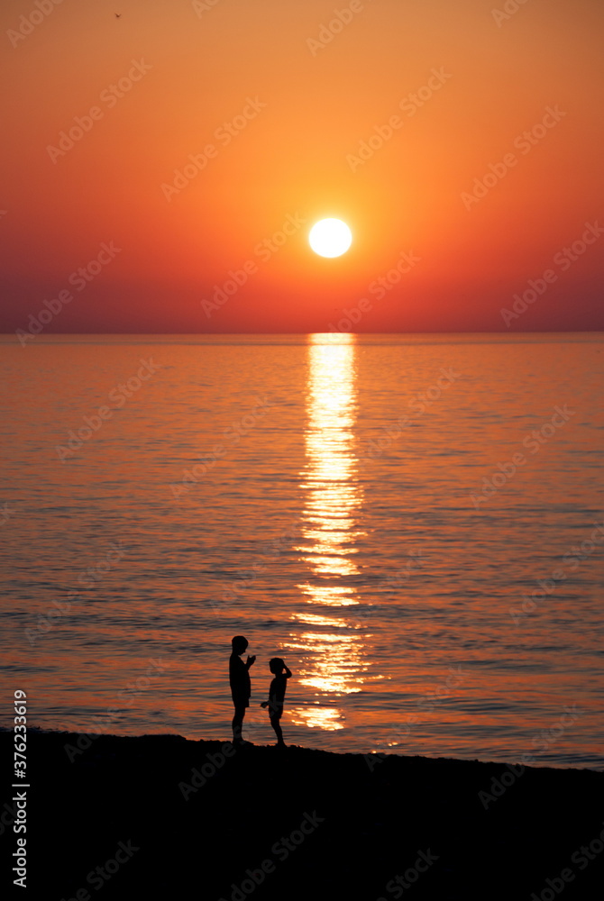 Children in sunset at the sea. Batumi. Georgia