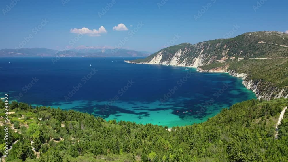 Aerial drone video of tropical paradise island covered in pine trees with turquoise crystal clear beach in Mediterranean destination Aerial drone video of tropical paradise island covered in pine trees with turquoise crystal clear beach in Mediterranean destination