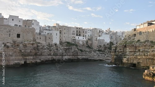 Slow Motion of the sunrise of Polignano a mare, Puglia, Italy. Cliff overlooking the sea photo