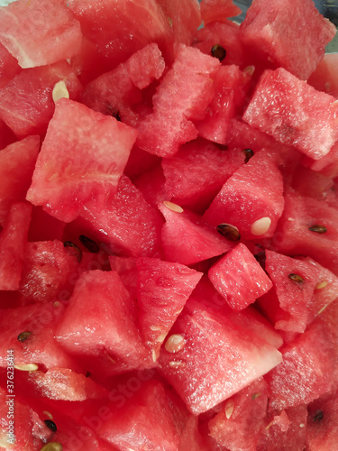 Chopped watermelon fruit cubes. Vertical close up.