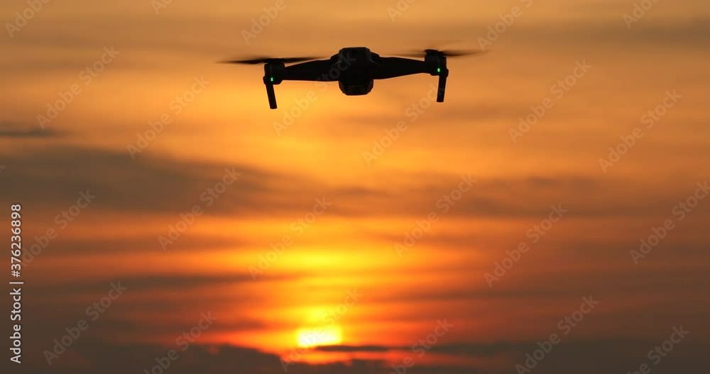 A silhouette of a Quadrocopter, flying in a beautiful sunset, drone in the sunset sky,A drone taking pictures of aerial views, A silhouette of a Quadrocopter, flying in a beautiful sunset, drone in the sunset sky,A drone taking pictures of aerial views,