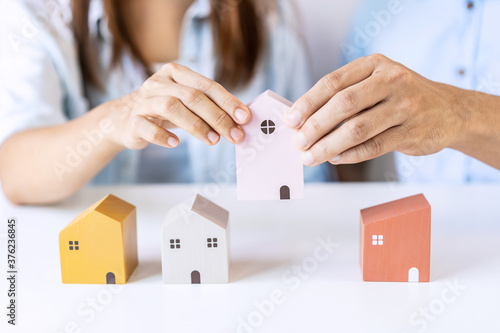 Young couple planning and looking for comparison information on their decision to buy a new home together