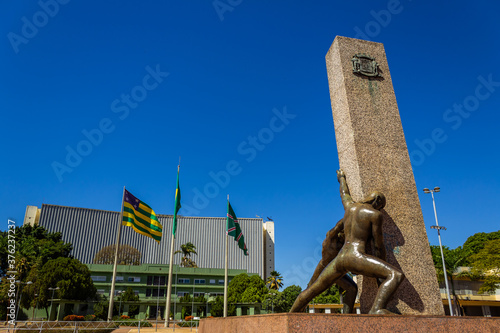 Detalhe da Praça Cívica em Goiânia - Monumento das Três Raças com céu azul e o Palácio das Esmeraldas ao fundo. photo