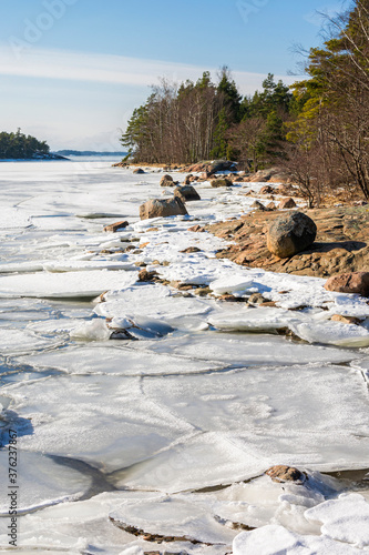 Coastal view in spring, rocks and frozen Gulf of Finland, Kopparnas-Klobbacka area, Inkoo, Finland