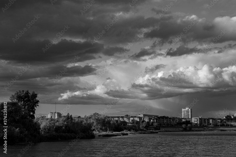 Beautiful clouds over the river and city Beautiful clouds over the river and city
