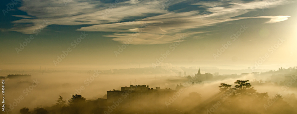 couché de soleil avec de la brume sur une ville proche de Lyon en France couché de soleil avec de la brume sur une ville proche de Lyon en France