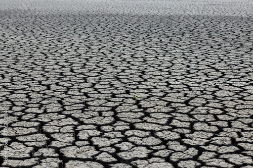 Part of a huge area of dried land suffering from drought in cracks.