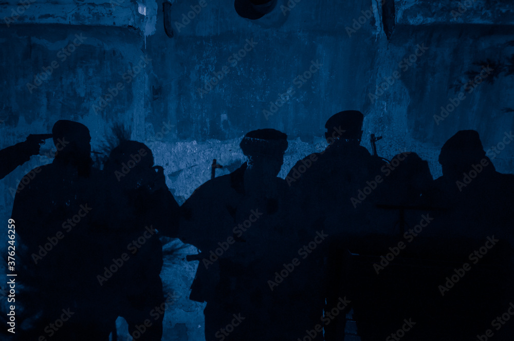 Shadow of soldiers on wall at night. Army concept. Fighting silhouettes on colored stone wall Shadow of soldiers on wall at night. Army concept. Fighting silhouettes on colored stone wall