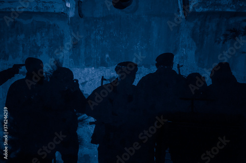 Shadow of soldiers on wall at night. Army concept. Fighting silhouettes on colored stone wall