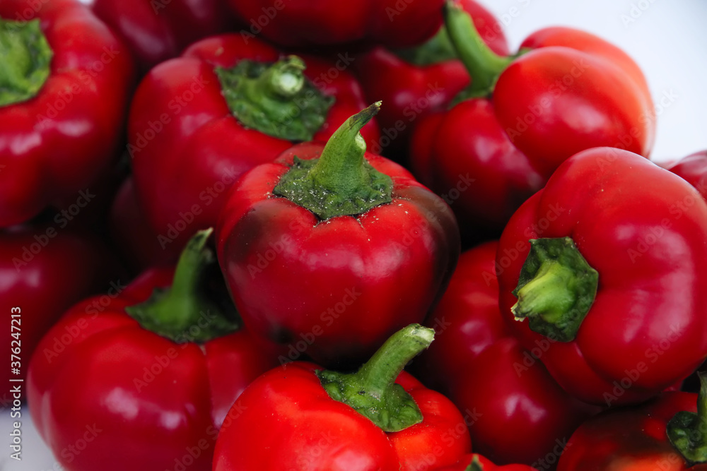 Red bell pepper on the counter in the supermarket. Large amount of red pepper in a heap