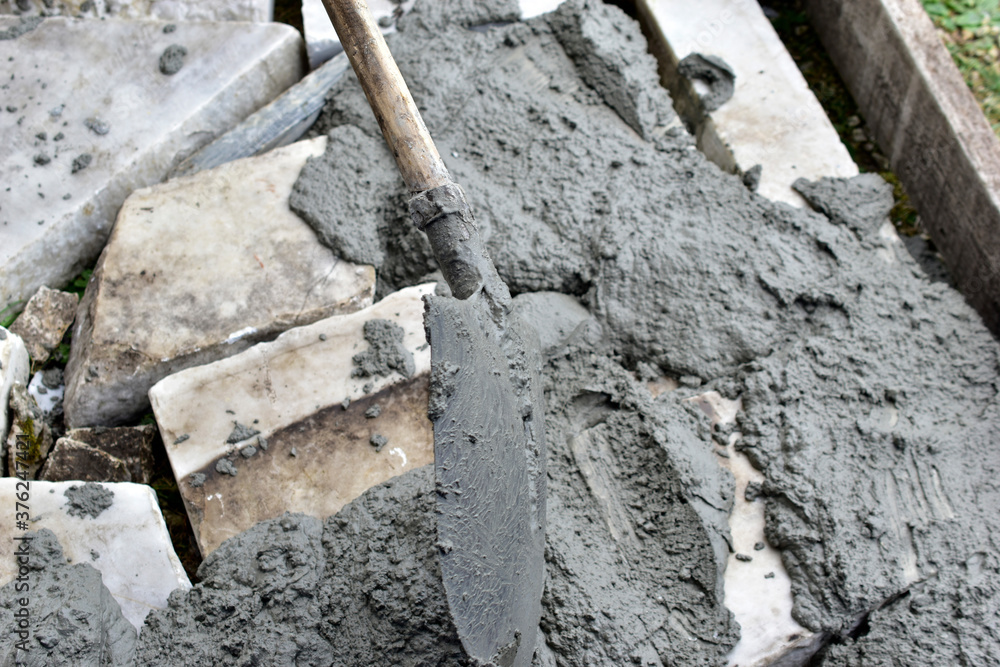 Mixing cement in the muld with shovels for construction Mixing cement in the muld with shovels for construction