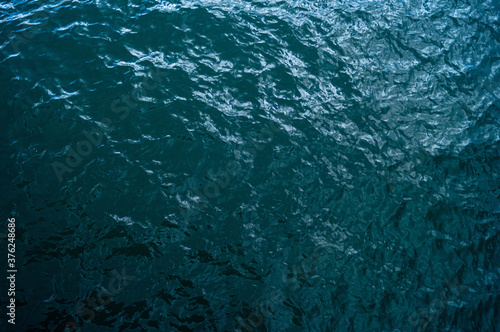 Sea waves, dark water of a beautiful color, top view. Horizontal photography.