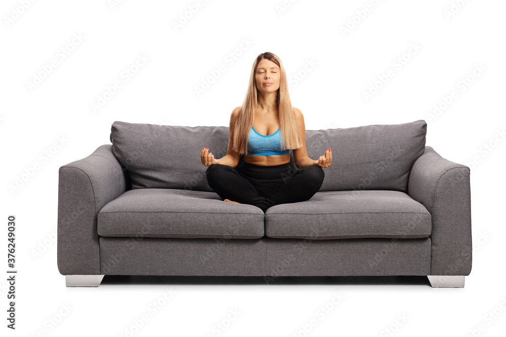 Young woman meditating on a couch