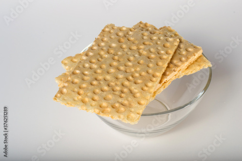 Crispbread on top of a glass bowl on a white background