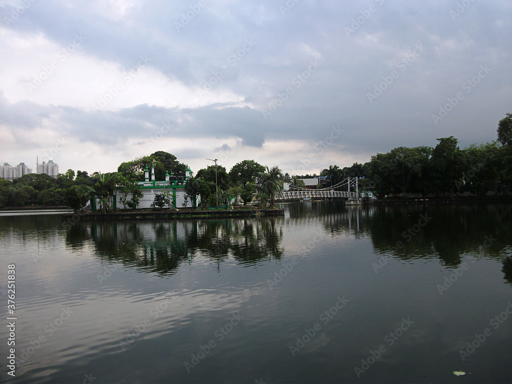 Mosque on the opposite side of the lake at Dhakuria Lake, Kolkata, India. Mosque on the opposite side of the lake at Dhakuria Lake, Kolkata, India.