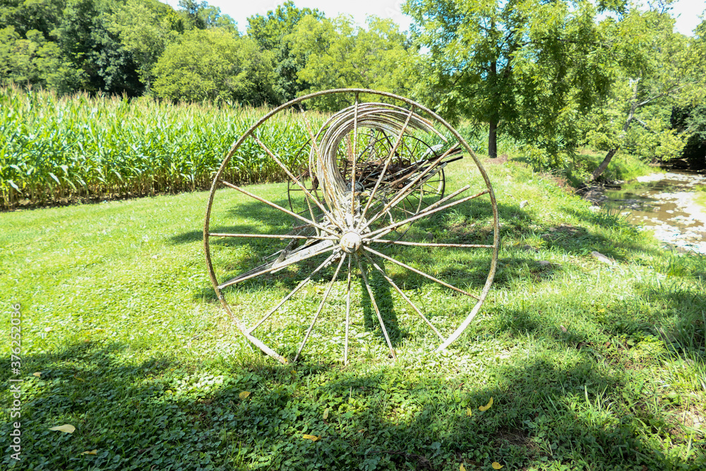 farming equipment by a cornfield