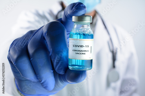 Doctor holds in hand a Coronavirus vaccine that is used for the prevention, immunization and treatment of Coronavirus - Covid-19