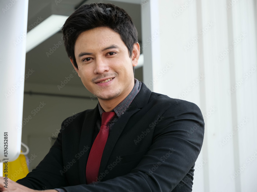Young Asian businessmen smile happily at work. Young Asian businessmen smile happily at work.