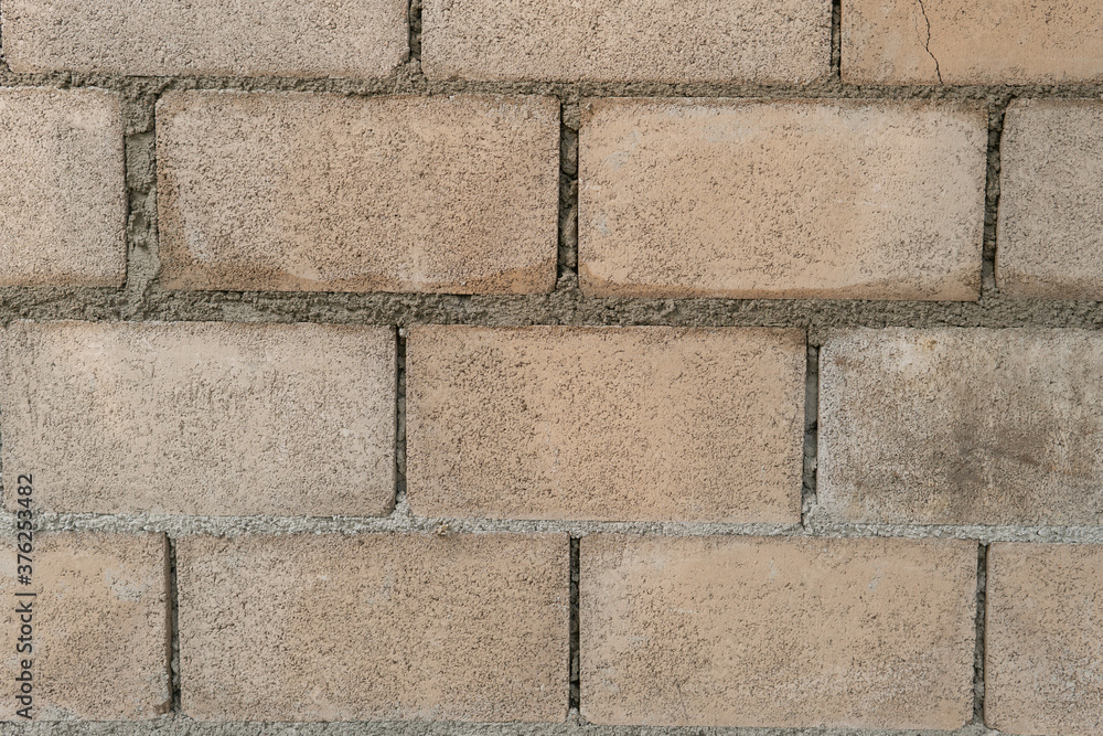 Obraz premium Wall of big brick white texture background. Texture of a brown stone wall construction.
