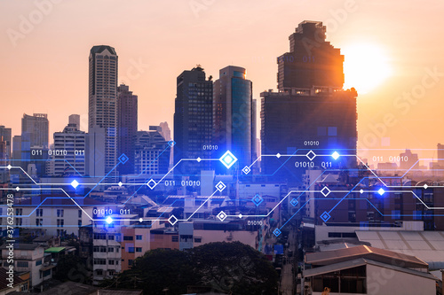 Glowing hologram of technological process  aerial panoramic cityscape of Bangkok at sunset. The largest innovative hub of tech services in Asia. Multi exposure.