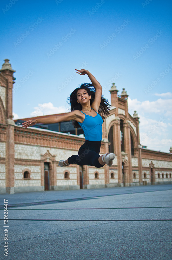 Ballerina jumping in the street