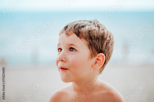 Portrait of a little boy surprised by the sea