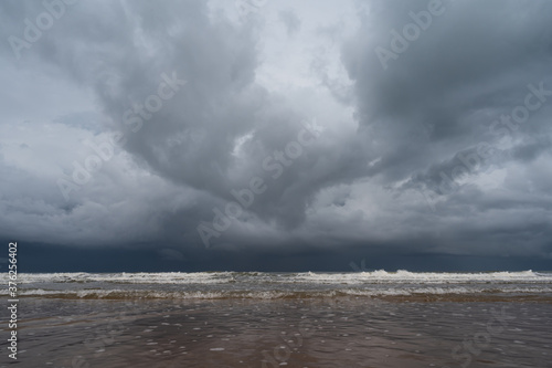 Storm clouds over the sea.The waves hit to the beach before rainy on seascape background.Bad weather for outdoor travel. © arcyto