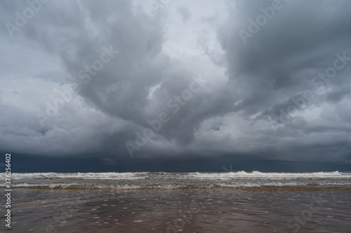 Storm clouds over the sea.The waves hit to the beach before rainy on seascape background.Bad weather for outdoor travel.