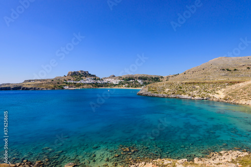A picturesque Bay with blue water near the village of Lindos, Rhodes island, Dodecanese, Greece.