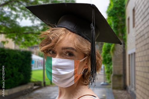 Student Graduation with  Irish ( Eire)  design protectice coronavirus face mask at the Graduation ceremony at University photo