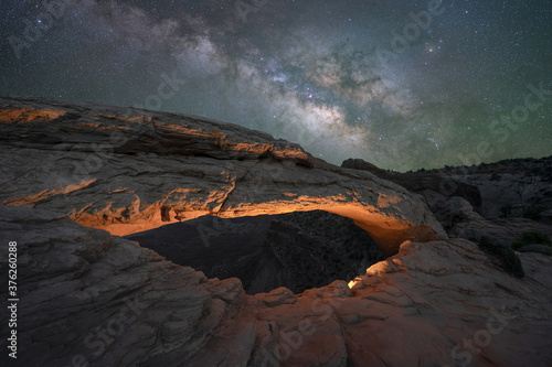 Mesa Arch lit at night under the Milky Way Galaxy