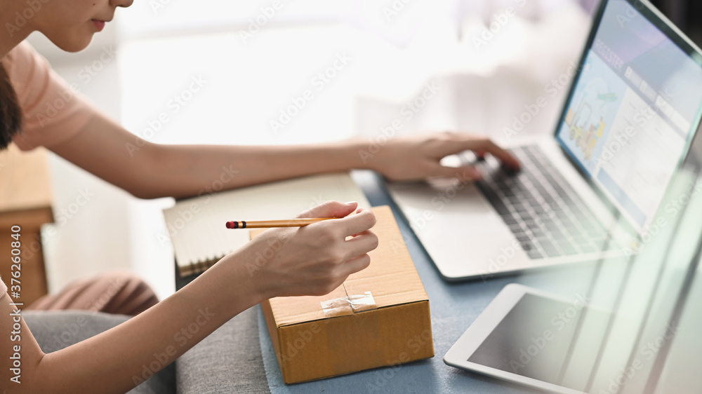 Young woman register supplies box on transportation system, her owner sme. Young woman register supplies box on transportation system, her owner sme.