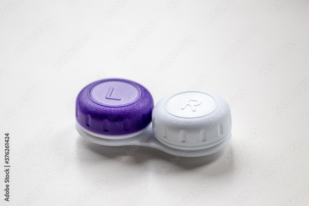 Contact lens container with contact lenses as optic alternative to glasses correct eyesight diseases like farsightedness and nearsightedness from a optician or eye doctor with medical hygiene concept Contact lens container with contact lenses as optic alternative to glasses correct eyesight diseases like farsightedness and nearsightedness from a optician or eye doctor with medical hygiene concept