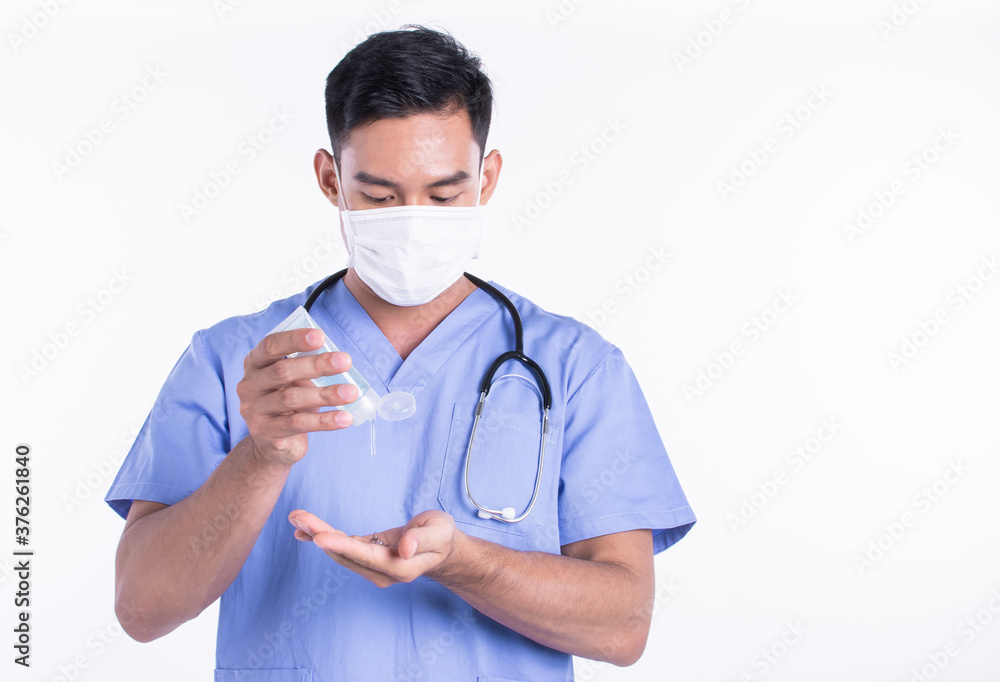 Asian male doctor wearing mask and using hand gel to protect virus Asian male doctor wearing mask and using hand gel to protect virus