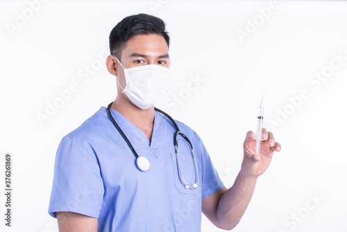 Asian male doctor wearing mask and using syringe for virus protection