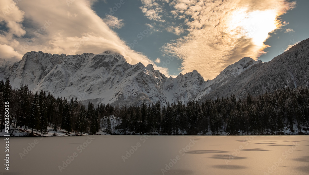 Obraz premium Frozen lake of fusine in a sunny afternoon, Friuli-Venezia Giulia, Italy