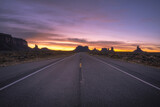 Road passing through Monument Valley at sunset