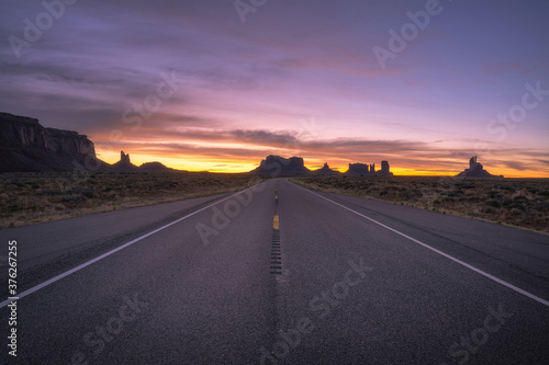 Road passing through Monument Valley at sunset