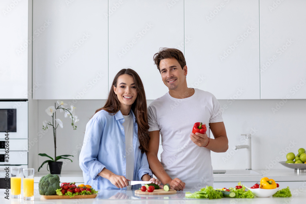 Happy couple is preparing healthy food on light kitchen, enjoy morning. Happy couple is preparing healthy food on light kitchen, enjoy morning.