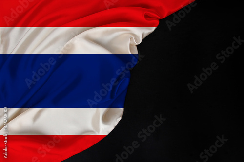 silk national flag of thailand state folded on black blank form  concept of tourism  economy  politics  emigration