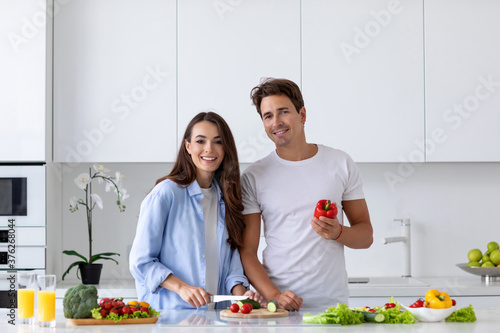 Happy couple is preparing healthy food on light kitchen, enjoy morning.