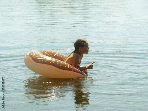 child bathes in the river © maksim28142