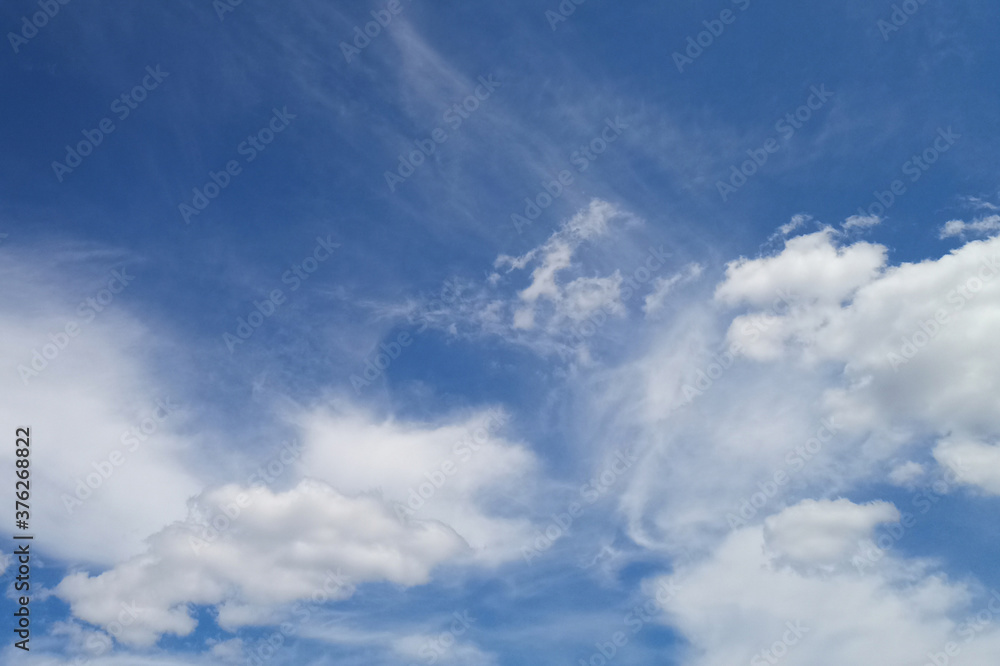 Blue sky with white cloud on a sunny day. Beautiful cirrus cloud texture
