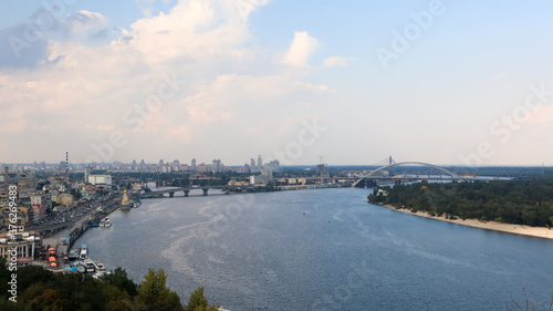 Top view of the old historical part of the city of Kiev. Vozdvizhenka area on Podol and the Dnieper river from the pedestrian bridge. Beautiful city landscape.  © Yevhen Roshchyn